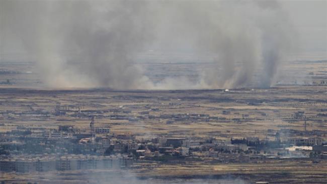 A picture taken from the Israeli-occupied Golan Heights shows smoke billowing from the Syrian side of the border on June 26, 2017. (Photo by AFP)