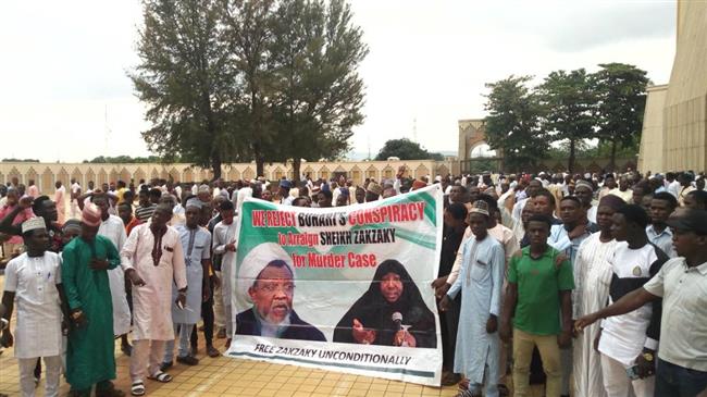 Supporters march with a banner to press for the release of Nigerian Muslim cleric Ibrahim Zakzaky.