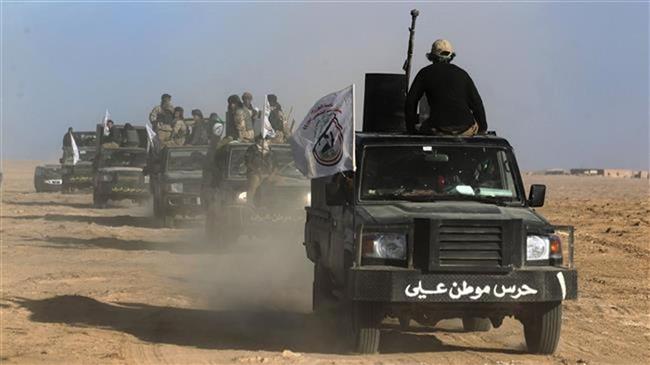 Iraqi forces, supported by members of the Popular Mobilization Units (Hashd al-Sha’abi), advance through Salahuddin province in the western desert bordering Syria after leaving the city of Baiji, on November 24, 2017. (Photo by AFP)