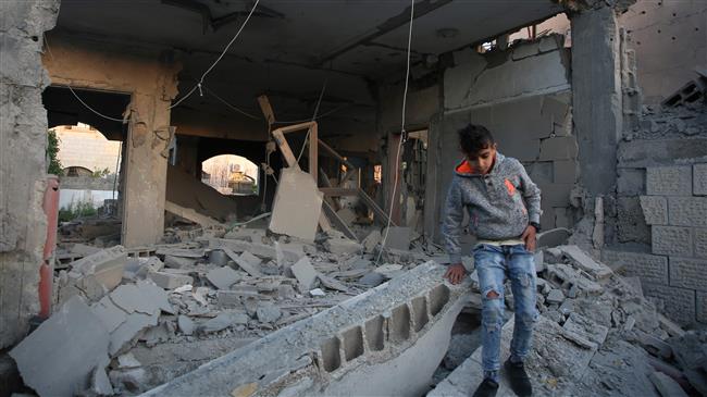 A Palestinian boy checks the house of a man suspected of murdering an Israeli rabbi in January 2018, after it was demolished by Israeli forces in the occupied West Bank city of Jenin on April 24, 2018. (Photo by AFP)