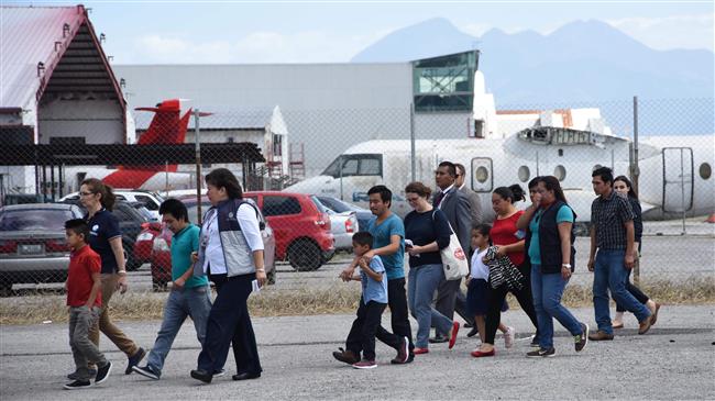 Members of Guatemalan immigrant families who tried to illegally cross to the United States, arrive at the Air Force base in Guatemala City after being deported on July 10, 2018. (Photo by AFP)