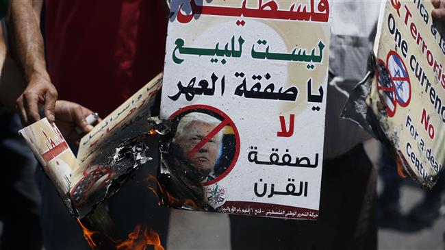 Palestinians burn portraits of US President Donald Trump during a demonstration in the city of Ramallah in the Israeli-occupied West Bank on July 2, 2018. (Photo by AFP)