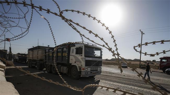 Trucks arrive at the Kerem Shalom crossing, the main passage point for goods entering the Gaza Strip, in the city of Rafah, on July 9, 2018. (Photo by AFP)