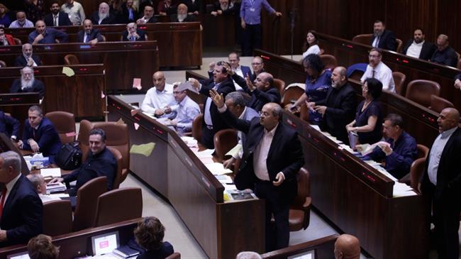 Arab lawmakers tear the nation-state bill in protest after it passes in the Israeli parliament on July 19, 2018.