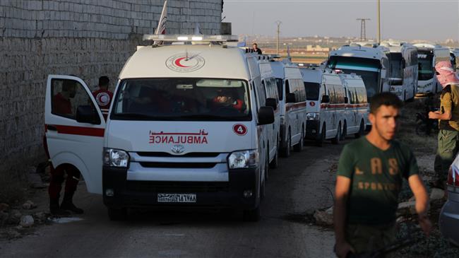 Hayat Tahrir al-Sham militants are seen near ambulances and buses outside the besieged towns of Kefraya and al-Foua, Idlib Province, Syria, July 18, 2018. (Photo by Reuters)