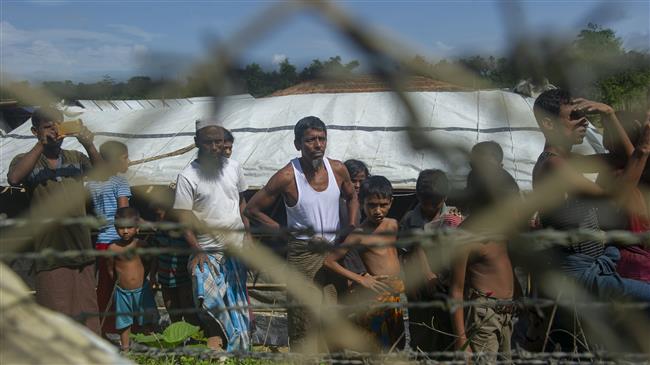 Rohingya Muslim refugees gather near the fence in the “no man’s land” between Myanmar and Bangladesh border as seen from Maungdaw, Rakhine State, Myanmar, on June 29, 2018. (Photo by AFP)