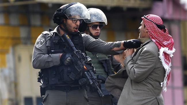 This AP file photo shows a Palestinian man being pushed by an Israeli policemen in al-Khalil (Hebron), occupied West Bank.