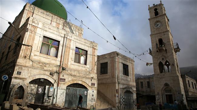 A Palestinian man walks along an empty street in the city of Nablus in the north of Israeli-occupied West Bank, May 15, 2018. (Photo by AFP)