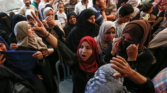 Relatives of killed Hamas member Mohamed Abu Daqa react and mourn during his funeral in Khan Yunis in the southern Gaza Strip on July 21, 2018.