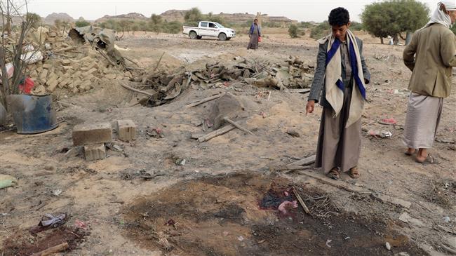 A Yemeni child looks at the site of a Saudi airstrike in the Sahar district of Sa