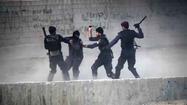 In this file picture, Bahraini forces arrest a protester during demonstration against the ruling Al Khalifah regime in the village of Shakhurah, west of Manama. (Photo by AFP)