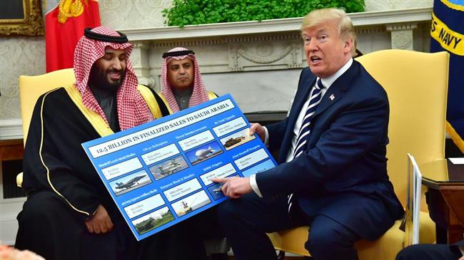 President Donald Trump holds up a chart of military hardware sales as he meets with Crown Prince Mohammed bin Salman of Saudi Arabia in the Oval Office at the White House, March 20, 2018. (Photo by EFE)