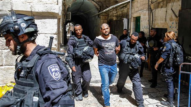 Israeli forces take into custody a Palestinian protester, who was arrested during clashes at the Aqsa Mosque compound in the Old City of Jerusalem al-Quds on July 27, 2018. (Photo by AFP)