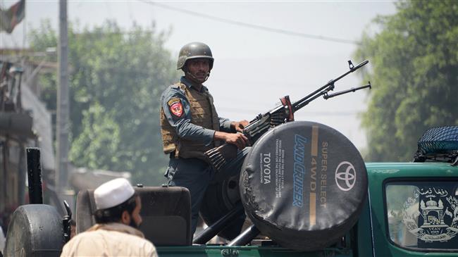 An Afghan soldier stands guard atop a vehicle near the site of an attack in Jalalabad on July 31, 2018. (Photo by AFP)