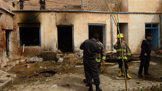 Firefighters and members of security forces inspect the site of a bomb attack at a Shia mosque in Herat, Afghanistan, March 25, 2018. (AFP)