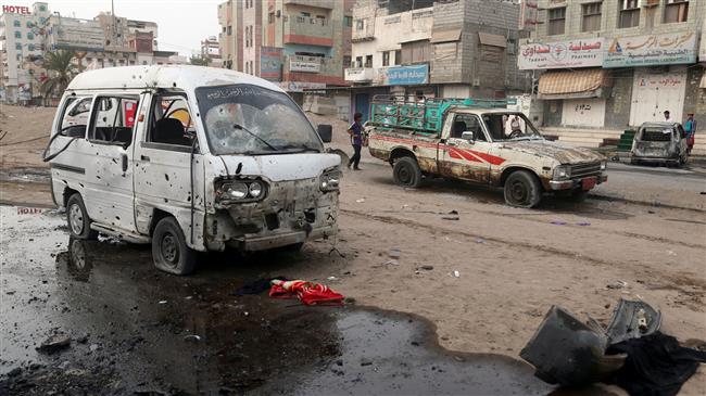 People walk past damaged cars at the entrance of al-Thawra hospital after an airstrike in the Yemeni Red Sea port city of al-Hudaydah on August 2, 2018. (Photo by AFP)