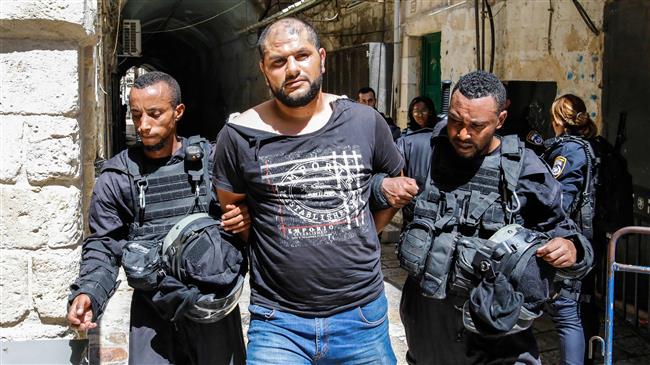 Israeli forces arrest a Palestinian protester during clashes at the al-Aqsa Mosque compound in the occupied Old City of Jerusalem al-Quds on July 27, 2018. (Photo by AFP)