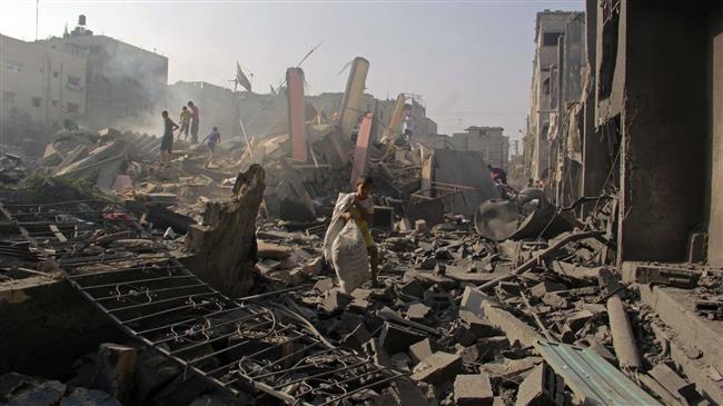 In this August 2, 2014 file photo, Palestinians search through rubble of homes destroyed in Israeli strikes in Rafah, southern Gaza Strip. (Photo by AP)