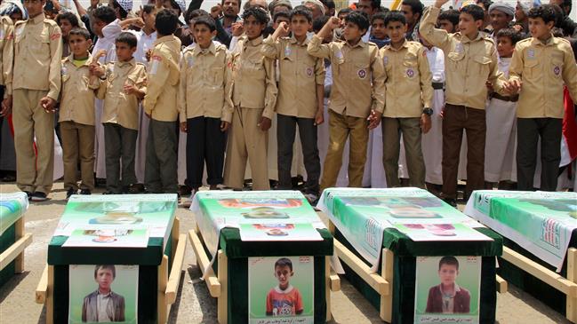 This photo shows Yemeni children taking part in a mass funeral for school children killed in an air strike by the Saudi-led coalition last week chanting slogans against the United States and Saudi Arabia. (Photo by AFP)