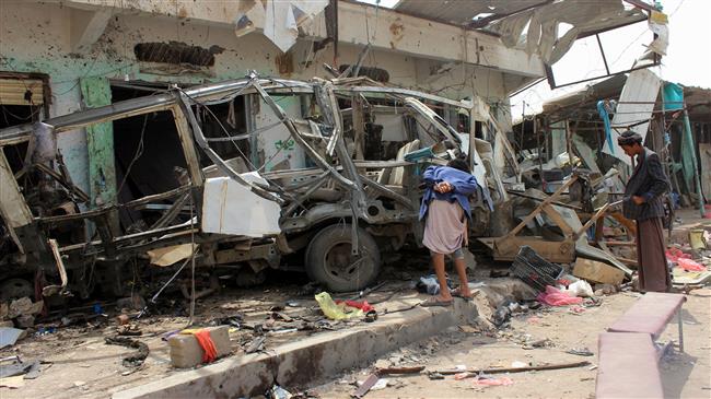 Yemenis gather next to a destroyed bus at the site of a Saudi-led airstrike that targeted the Dhahyan market the previous day in Sa’ada province, Yemen, on August 10, 2018. (Photo by AFP)