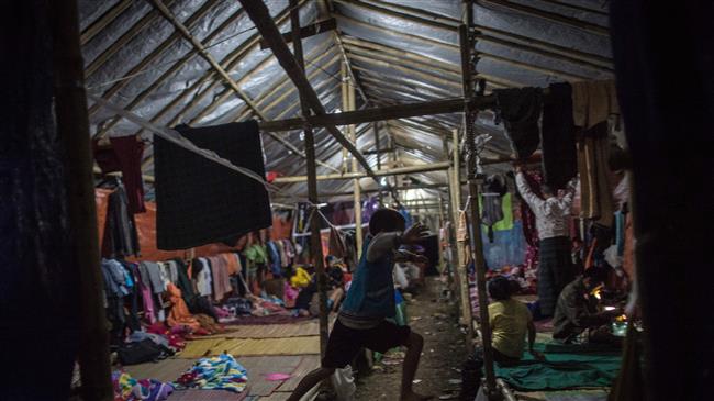 In this picture taken on May 11, 2018, a child jumps at a temporary shelter for internally displaced families in Danai, Kachin state, Myanmar. (Photo by AFP)
