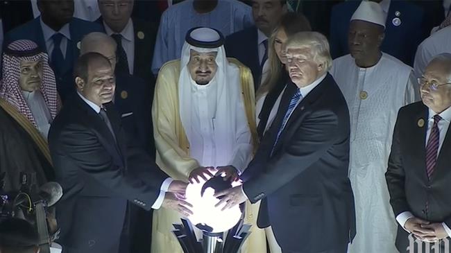 President Donald Trump, along with Saudi King Salman bin Abdulaziz and Egyptian President Abdel Fattah al-Sisi , places his hands on a glowing orb during inauguration of a center in Riyadh, Saudi Arabia May 21, 2017.