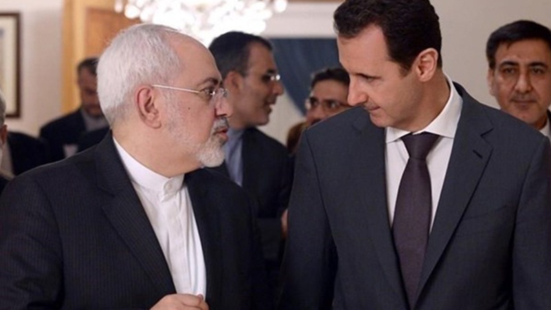 Syrian President Bashar al-Assad (R) and Iranian Foreign Minister Mohammad Javad Zarif meet in Damascus