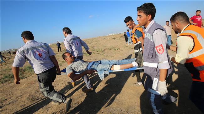 Palestinian paramedics carry an injured protester during a demonstration along the border fence between the Gaza Strip and Israeli-occupied territories east of Gaza City on September 14, 2018. (Photo by AFP)