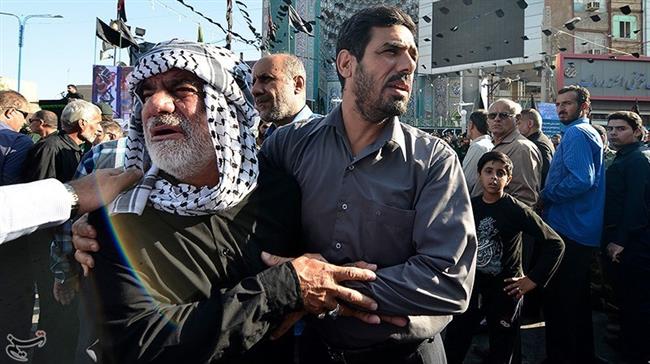 Iranian people are seen during a funeral procession for the victims of a Saturday terrorist attack in Iran