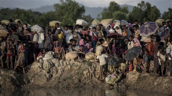 This file photo, taken on October 10, 2017, shows Rohingya refugees fleeing from Myanmar at the Naf River in Whaikyang, on the border with Bangladesh. (By AFP)