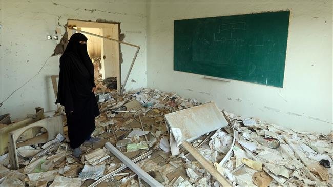 The file photo shows a Yemeni woman, member of a school administration, inspecting the damage on the first day of the new academic year on September 16, 2018, at a school that was damaged last year in a Saudi-led airstrike in Yemen’s third city of Ta’izz. (Photo by AFP)