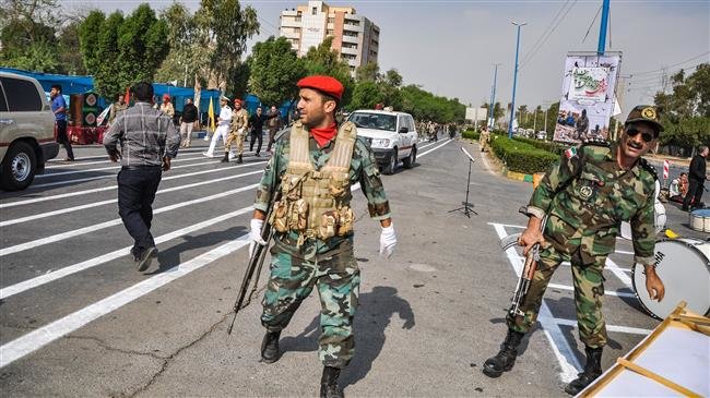 This picture taken on September 22, 2018 in the southwestern Iranian city of Ahvaz shows soldiers at the scene of an attack on a military parade that was marking the anniversary of the outbreak of its devastating 1980-1988 war with Saddam Hussein (Source: AFP)