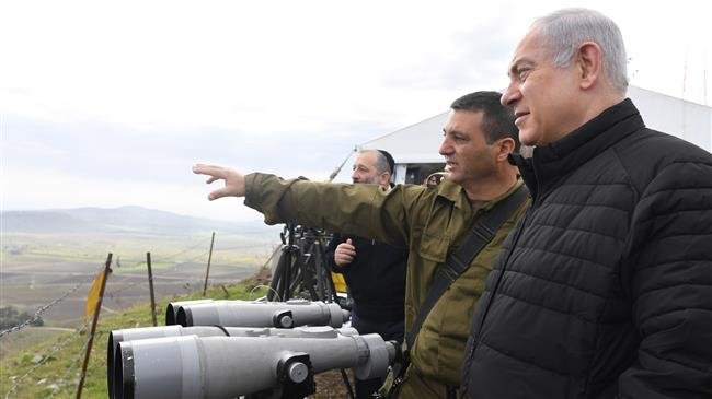 Israeli Prime Minister Benjamin Netanyahu (R) seen in this handout photo during a visit to the Golan Heights in February 2016.