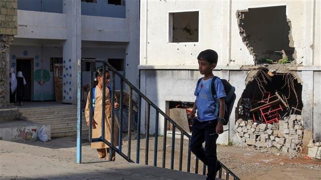 Yemeni students walk on the first day of the new academic year on September 16, 2018, at a school that was damaged by an airstrike last year. (Photo by AFP)