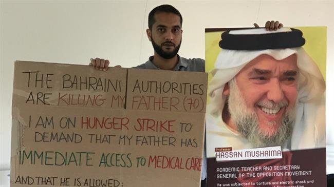 File photo shows Ali Mushaima, the son of the Bahraini activist Hassaan Mushaima, holding banners and pictures urging the release of his father from jail in Bahrain in front of the Bahraini embassy in London.