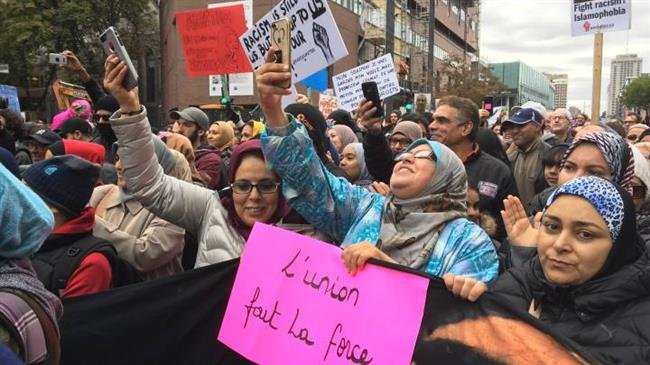 This photo taken from the website of Global News shows Muslim women attending an anti-racism rally in Montreal, Quebec Province, Canada, October 7, 2018.