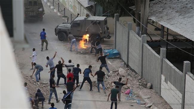 Protesters throw stones and Molotov cocktails at Israeli forces in the village of Shuwaykah in the occupied West Bank on October 7, 2018. (Photo by AFP)