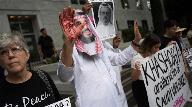A demonstrator dressed as Saudi Arabian Crown Prince Mohammed bin Salman (C) with blood on his hands protests outside the Saudi embassy in Washington, DC, on October 8, 2018. (Photo by AFP)