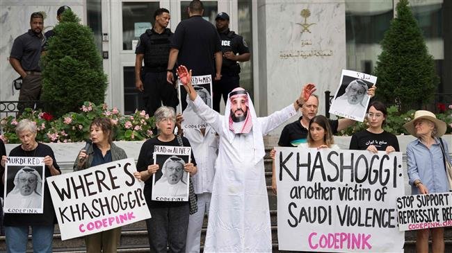 A demonstrator dressed as Saudi Arabian Crown Prince Mohammed bin Salman (C) with blood on his hands protests with others outside the Saudi Embassy in Washington, DC, on October 8, 2018, demanding justice for missing Saudi journalist Jamal Khashoggi. (Photo by AFP)