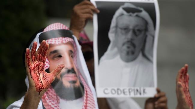 A demonstrator dressed as Saudi Arabian Crown Prince Mohammed bin Salman (C) with blood on his hands protests outside the Saudi Embassy in Washington, DC, on October 8, 2018. (Photo by AFP)