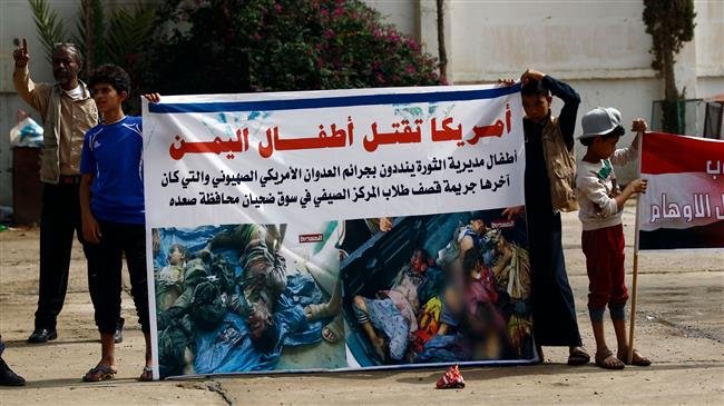 Yemeni children raise pictures during a demonstration in the capital, Sana