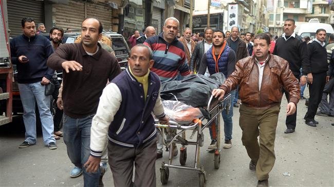 In this file photo taken on April 09, 2017, Egyptians wheel away a body near a church in Alexandria after a bomb blast struck worshipers gathering to celebrate Palm Sunday. (Photo by AFP)