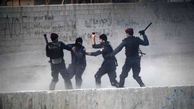In this file picture, Bahraini regime forces arrest a protester during demonstration against the ruling Al Khalifah regime in the village of Shakhura, west of Manama. (By AFP)