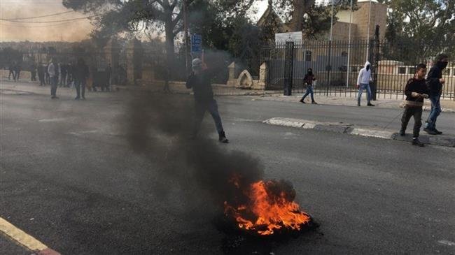 Young Palestinians hurl stones at Israeli military forces in the town of Tuqu’, occupied West Bank, on November 11, 2018. (Photo by the Palestinian Information Center)