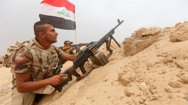 In this file picture, Iraqi fighters from Popular Mobilization Units hold a position on the Tharthar frontline on the edge of the western province of Anbar. (Photo by AFP)