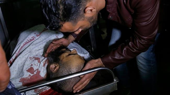 A man looks at the body of Nour Baraka, a commander for Hamas