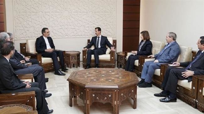 Hossein Jaberi Ansari, senior assistant to the Iranian foreign minister on special political affairs, (C-L) meets with Syrian President Bashar al-Assad (C-R) in Damascus on November 12, 2018. (Photo by SANA)
