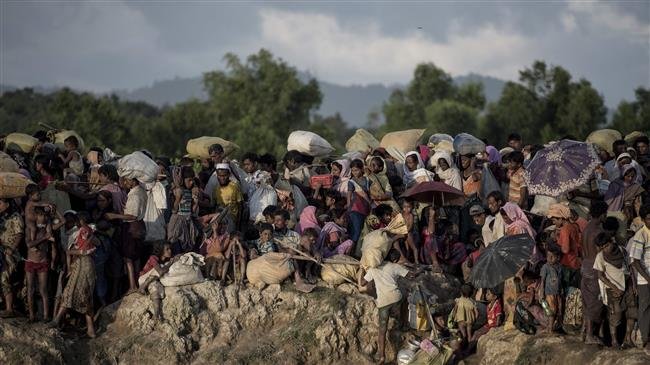 This file photo, taken on October 10, 2017, shows Rohingya Muslim refugees fleeing from Myanmar at the Naf river in Whaikyang, Bangladesh border. (Photo by AFP)