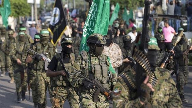 In this file picture, fighters from al-Qassam Brigades, the military wing of Hamas resistance movement, take part in a parade in Gaza City. (Photo by AFP)