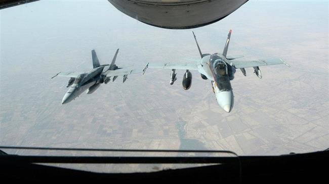 In this file picture released by the US Department of Defense, a pair of US-led coalition military aircraft flies in the sky after airstrikes against purported Daesh targets in Syria.